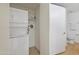 Efficient laundry area with stacked washer and dryer, and organized shelving for storage solutions at 7137 E Rancho Vista Dr # 3007, Scottsdale, AZ 85251