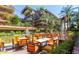 Outdoor patio with dining tables, chairs, and leafy plants at 7137 E Rancho Vista Dr # 3007, Scottsdale, AZ 85251