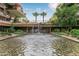 Attractive stone water feature surrounded by lush green plantings, and palm trees at 7137 E Rancho Vista Dr # 3007, Scottsdale, AZ 85251