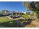 Inviting backyard with a sparkling pool, lush landscaping, and patio seating for outdoor relaxation at 7471 E Northern Ave, Scottsdale, AZ 85258