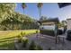 Backyard patio offers ample seating with a charming porch swing, ideal for enjoying the manicured landscape at 7471 E Northern Ave, Scottsdale, AZ 85258