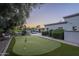 Lush backyard with putting green and pool offers an inviting space for leisure and outdoor activities at 7471 E Northern Ave, Scottsdale, AZ 85258