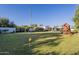 Large backyard with play structure and grass, trees and mature landscaping at 7471 E Northern Ave, Scottsdale, AZ 85258