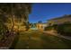 Manicured backyard with putting green, lighted pool and covered patio at 7471 E Northern Ave, Scottsdale, AZ 85258