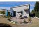 The backyard patio features a swing, seating and desert landscaping at 7471 E Northern Ave, Scottsdale, AZ 85258