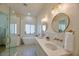 Bright bathroom boasts double sinks, round mirrors, stylish tile flooring, and a separate soaking tub at 7471 E Northern Ave, Scottsdale, AZ 85258