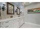 Spacious bathroom with double vanity, marble countertop, and decorative sconces at 7471 E Northern Ave, Scottsdale, AZ 85258