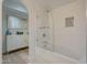 Bathroom with a glass-enclosed shower and subway tile, plus storage cabinet at 7471 E Northern Ave, Scottsdale, AZ 85258