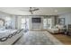 Spacious bedroom with treadmill, wood floors, ceiling fan, comfortable seating, and patio access at 7471 E Northern Ave, Scottsdale, AZ 85258
