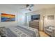 Neutral bedroom with ceiling fan, TV, closet, dresser, and art at 7471 E Northern Ave, Scottsdale, AZ 85258