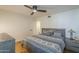 Cozy bedroom featuring a ceiling fan and a decorative comforter set on the bed at 7471 E Northern Ave, Scottsdale, AZ 85258