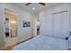 Bright bedroom features hardwood floors, a ceiling fan, a modern closet, and ensuite bathroom access at 7471 E Northern Ave, Scottsdale, AZ 85258
