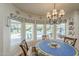 Bright dining area with backyard pool view through large windows with blue patterned valances at 7471 E Northern Ave, Scottsdale, AZ 85258