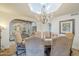 Cozy dining area featuring elegant chandelier, stylish table setting, and open access to other rooms at 7471 E Northern Ave, Scottsdale, AZ 85258