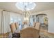 Bright dining room with statement chandelier, skylight, and access to outdoor space at 7471 E Northern Ave, Scottsdale, AZ 85258