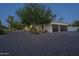 Paver driveway leading to a home with well-maintained landscaping and a two-car garage at 7471 E Northern Ave, Scottsdale, AZ 85258