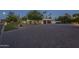 Paver driveway leading to a home with well-maintained landscaping and a two-car garage at 7471 E Northern Ave, Scottsdale, AZ 85258