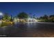 Long brick driveway approaching a luxurious home with a three-car garage and mature trees at 7471 E Northern Ave, Scottsdale, AZ 85258