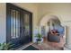 Elegant home entrance featuring ornate double doors and a covered patio with comfortable seating at 7471 E Northern Ave, Scottsdale, AZ 85258