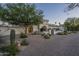 Charming desert home with paver driveway, gated entrance, and lush, low-maintenance landscaping at 7471 E Northern Ave, Scottsdale, AZ 85258