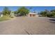 Spacious property with a well-paved driveway, lush landscaping, and a charming home with a two-car garage at 7471 E Northern Ave, Scottsdale, AZ 85258