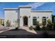 Exterior of a house featuring desert landscaping with pavers, a security door, and dark trim at 7471 E Northern Ave, Scottsdale, AZ 85258