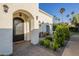 Charming front entrance featuring an ornate door, manicured landscaping, and cozy seating area at 7471 E Northern Ave, Scottsdale, AZ 85258