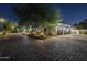 Close-up of a three-car garage on a home with mature trees and an ornate brick driveway at 7471 E Northern Ave, Scottsdale, AZ 85258