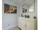 Hallway with decorative cabinet, accented by artwork and a silver framed mirror at 7471 E Northern Ave, Scottsdale, AZ 85258