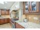 The kitchen showcases custom cabinetry and a stainless steel cooktop against a patterned backsplash at 7471 E Northern Ave, Scottsdale, AZ 85258