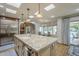Kitchen view highlighting large island, skylights, stainless steel refrigerator, and breakfast nook at 7471 E Northern Ave, Scottsdale, AZ 85258