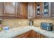 Close-up of kitchen counter with granite countertops and custom wood cabinetry at 7471 E Northern Ave, Scottsdale, AZ 85258