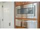 Kitchen features stainless steel microwave and oven built into the custom cabinetry at 7471 E Northern Ave, Scottsdale, AZ 85258