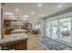 Open kitchen and dining area with backyard pool view, stainless appliances, and hardwood floors at 7471 E Northern Ave, Scottsdale, AZ 85258