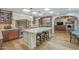 Open kitchen with stainless steel appliances, large island, and breakfast bar seating at 7471 E Northern Ave, Scottsdale, AZ 85258