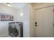 Functional laundry room with modern washer/dryer, ample storage, and tiled flooring at 7471 E Northern Ave, Scottsdale, AZ 85258