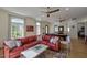 Large living room features a red sectional sofa, neutral walls, hardwood floors, and a pool table at 7471 E Northern Ave, Scottsdale, AZ 85258
