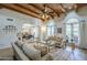 Inviting living room with wood beam ceiling, comfortable seating, and arched doorways at 7471 E Northern Ave, Scottsdale, AZ 85258