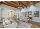 Warm living room featuring exposed wood beams, neutral decor, and ample natural light at 7471 E Northern Ave, Scottsdale, AZ 85258