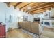 Open living space with wood beams, cozy fireplace, and ample seating at 7471 E Northern Ave, Scottsdale, AZ 85258