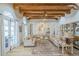 Bright living room with wood beam ceiling, arched doorway and neutral color palette at 7471 E Northern Ave, Scottsdale, AZ 85258