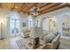 Elegant living area with beamed ceiling, arched windows, and cozy seating arrangement at 7471 E Northern Ave, Scottsdale, AZ 85258