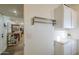 Mud room area with storage cabinet, drying rack, and adjacent open concept kitchen at 7471 E Northern Ave, Scottsdale, AZ 85258