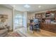 Well-lit office with a large window, hardwood floors, and built-in shelves and desk at 7471 E Northern Ave, Scottsdale, AZ 85258