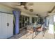 Covered patio boasts stylish tile flooring, a ceiling fan, outdoor dining, and exterior access at 7471 E Northern Ave, Scottsdale, AZ 85258