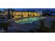 Serene pool area features lounge seating and dining and an inviting illuminated pool at 7471 E Northern Ave, Scottsdale, AZ 85258