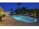 Backyard oasis with a sparkling pool, lush landscaping, and tranquil waterfall feature at 7471 E Northern Ave, Scottsdale, AZ 85258