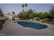 Inviting pool area with mature trees, landscaping, and a water feature for relaxation at 7471 E Northern Ave, Scottsdale, AZ 85258