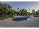 Sparkling pool area with mature trees, landscaping, and a water feature for relaxation at 7471 E Northern Ave, Scottsdale, AZ 85258