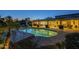 Sparkling pool with an illuminated patio and outdoor seating, perfect for evening relaxation at 7471 E Northern Ave, Scottsdale, AZ 85258